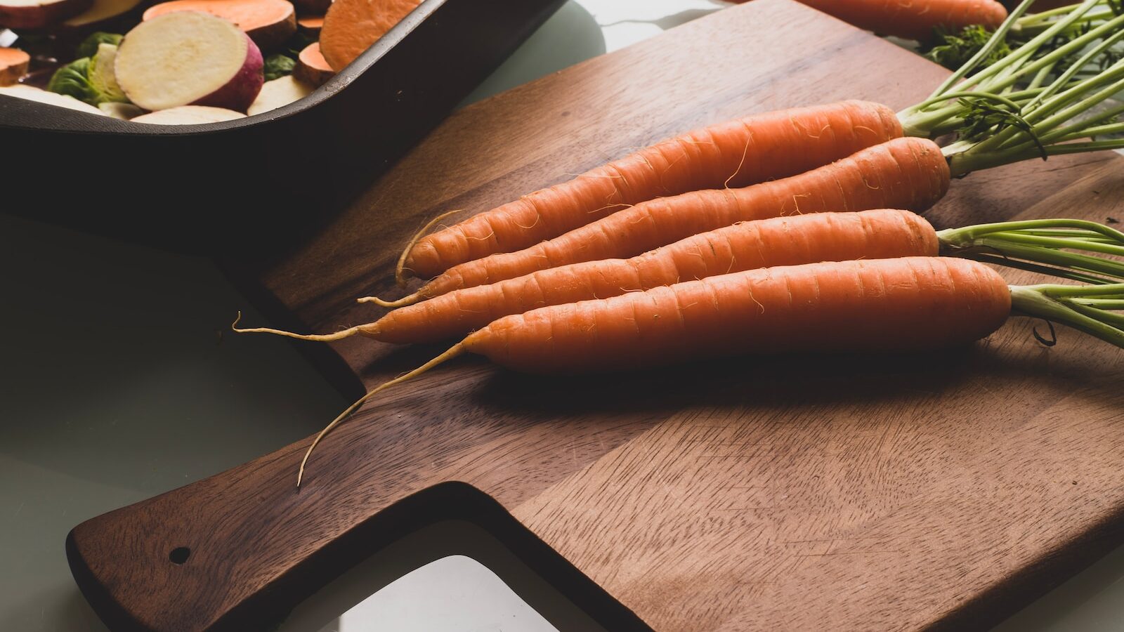 orange carrots on brown wooden table