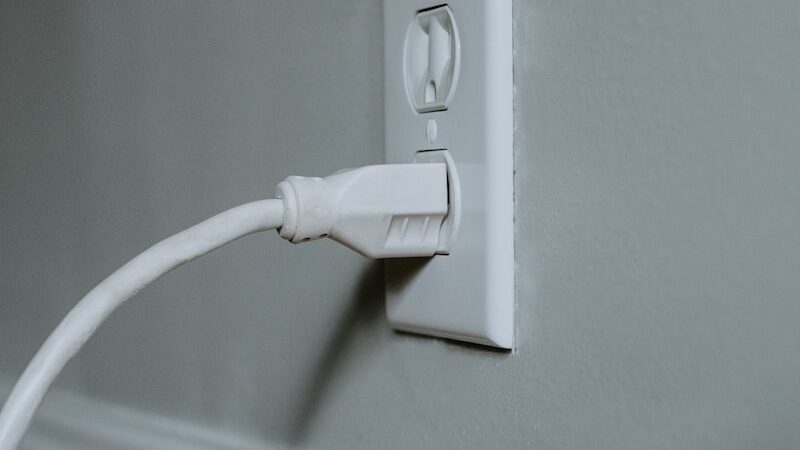 white usb cable plugged in white electric socket